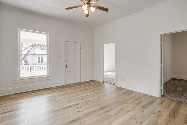 empty room with light wood-style flooring and crown molding