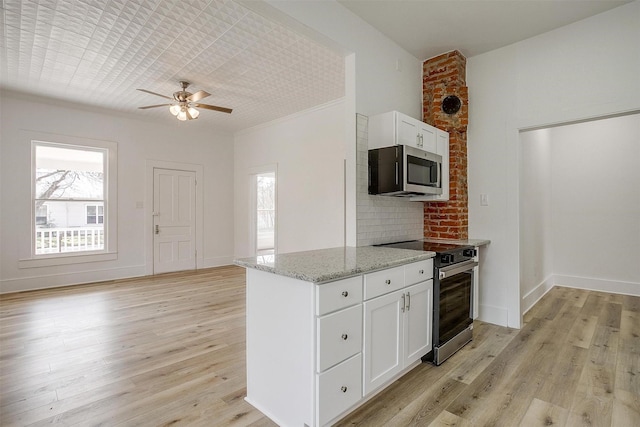 kitchen featuring stainless steel appliances, baseboards, white cabinets, light stone countertops, and light wood finished floors