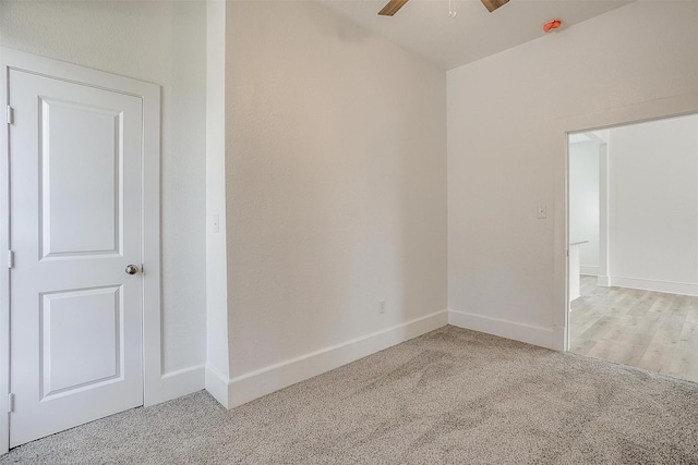 empty room with carpet, ceiling fan, and baseboards