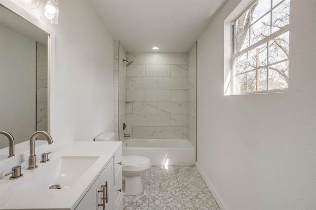 bathroom featuring toilet, baseboards,  shower combination, and vanity