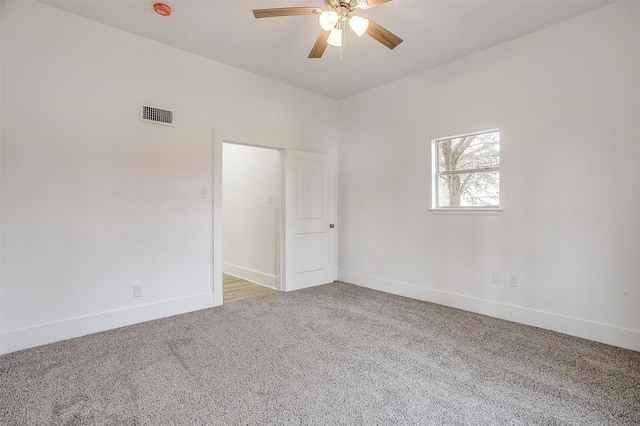 unfurnished room with light colored carpet, visible vents, ceiling fan, and baseboards