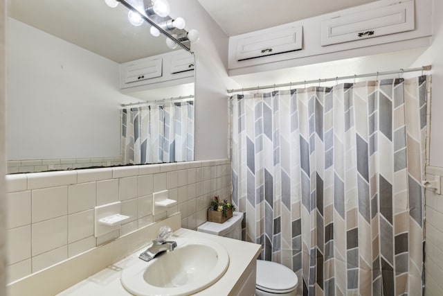 full bath featuring curtained shower, vanity, toilet, and tile walls