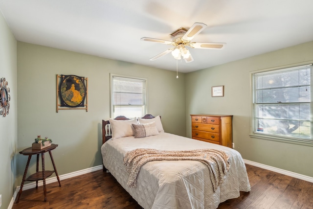 bedroom with dark wood-type flooring, baseboards, and a ceiling fan