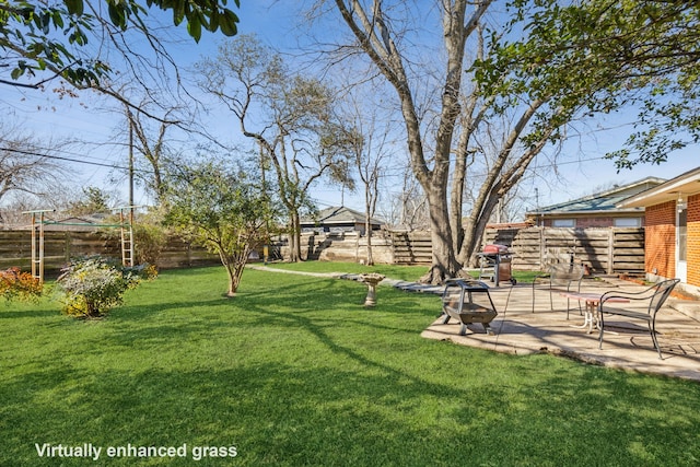 view of yard featuring an outdoor fire pit, a patio area, and a fenced backyard