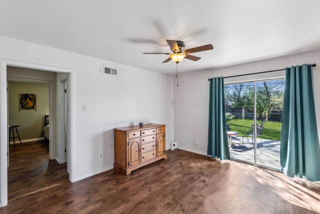 unfurnished bedroom with access to outside, visible vents, dark wood finished floors, and baseboards