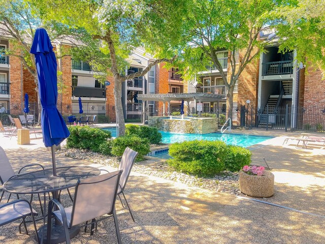 18333 Roehampton Dr Unit 123, Dallas, TX 75252 - community pool featuring a pergola and a patio area