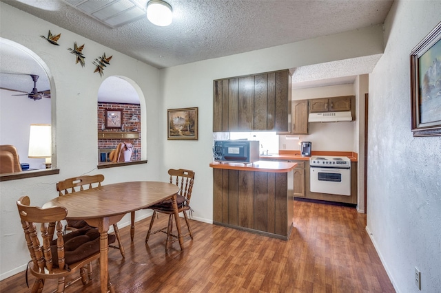 kitchen featuring electric range, a textured ceiling, light wood-type flooring, under cabinet range hood, and black microwave