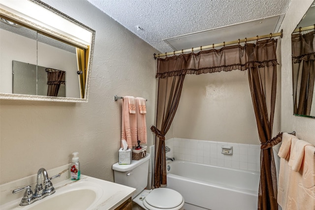 bathroom featuring a textured ceiling, a textured wall, vanity, and toilet