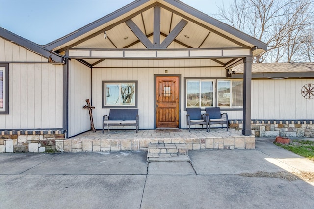 view of exterior entry featuring a porch