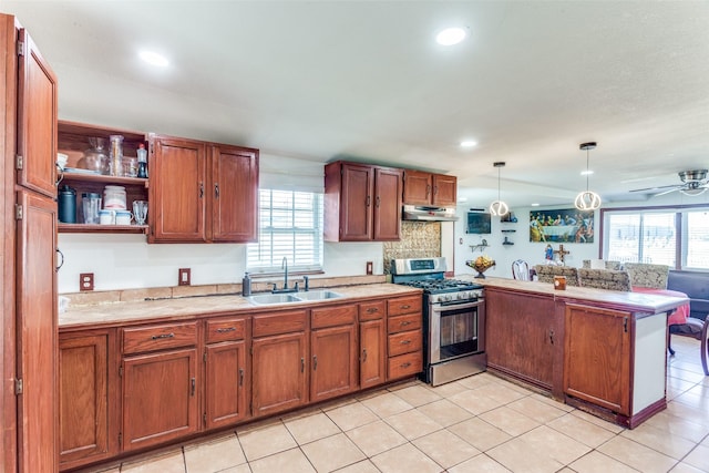 kitchen with a wealth of natural light, gas stove, a sink, and a peninsula