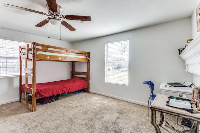 bedroom with carpet floors, ceiling fan, and baseboards