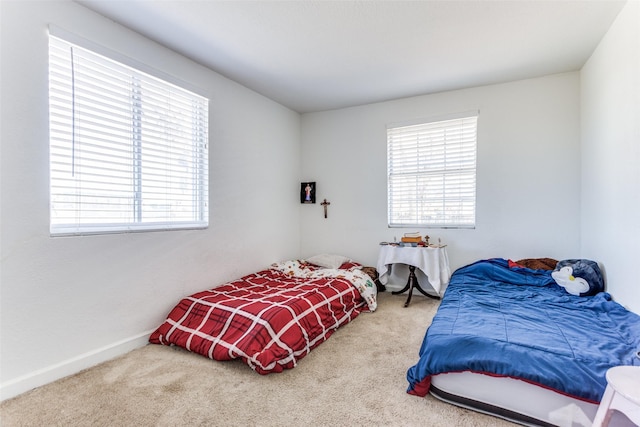 carpeted bedroom with baseboards