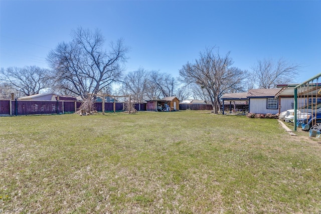 view of yard featuring an outbuilding and a fenced backyard