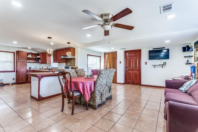 dining space with baseboards, visible vents, a wealth of natural light, and light tile patterned flooring