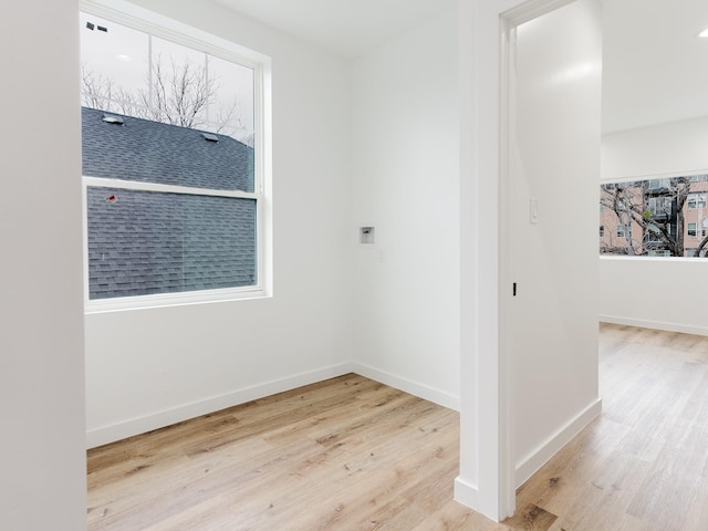 interior space with baseboards and wood finished floors