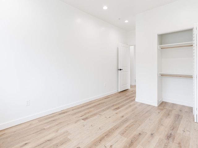 unfurnished bedroom featuring recessed lighting, a closet, baseboards, and light wood finished floors