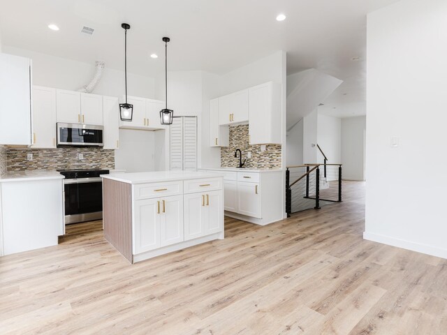 kitchen with visible vents, light countertops, appliances with stainless steel finishes, light wood-style floors, and white cabinetry