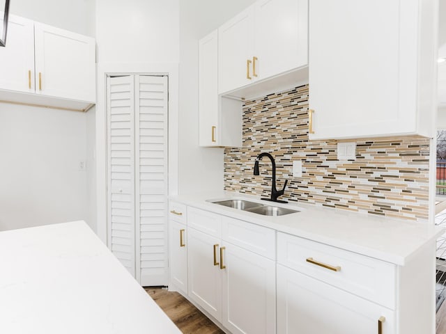 kitchen featuring a sink, white cabinetry, and light countertops