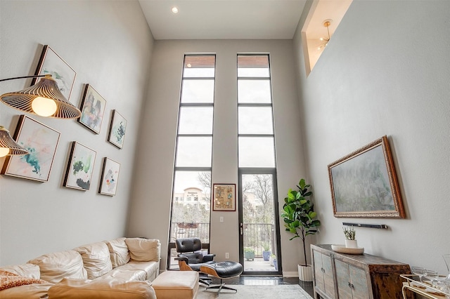 living room featuring a wealth of natural light and a towering ceiling