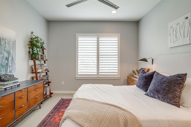 bedroom with light carpet and baseboards