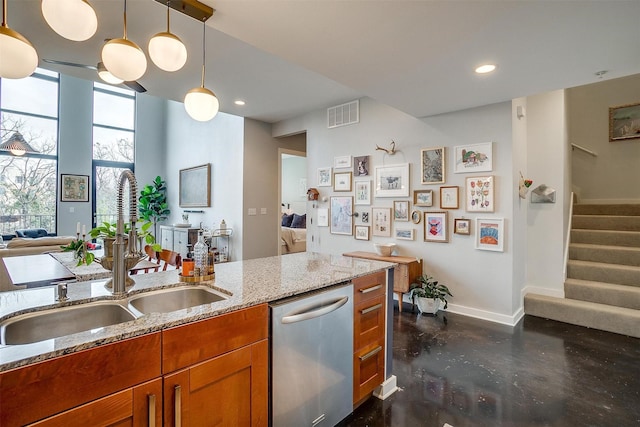 kitchen featuring baseboards, visible vents, brown cabinetry, dishwasher, and a sink