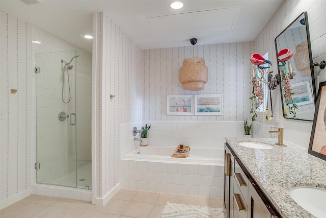 bathroom with a sink, a stall shower, tile patterned flooring, and wallpapered walls