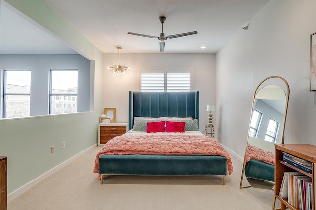 bedroom featuring carpet floors, multiple windows, and baseboards