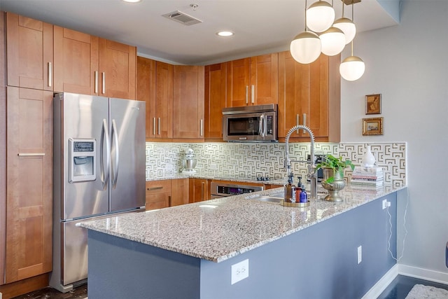 kitchen featuring tasteful backsplash, visible vents, a peninsula, light stone countertops, and stainless steel appliances