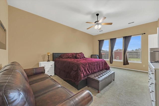 bedroom featuring baseboards, ceiling fan, visible vents, and light colored carpet