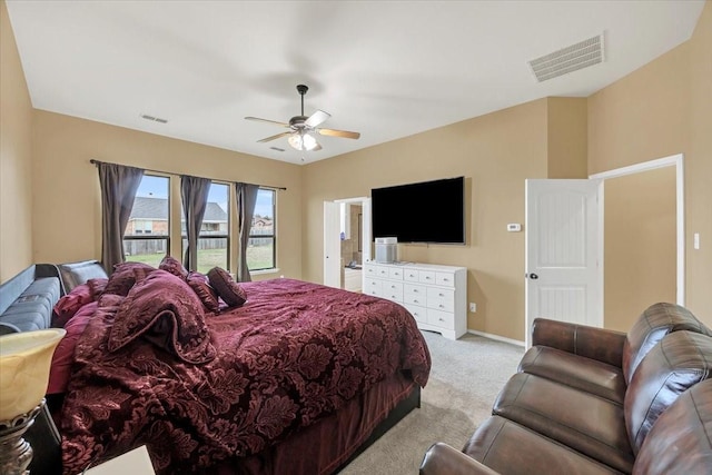 bedroom featuring baseboards, visible vents, ceiling fan, and light colored carpet