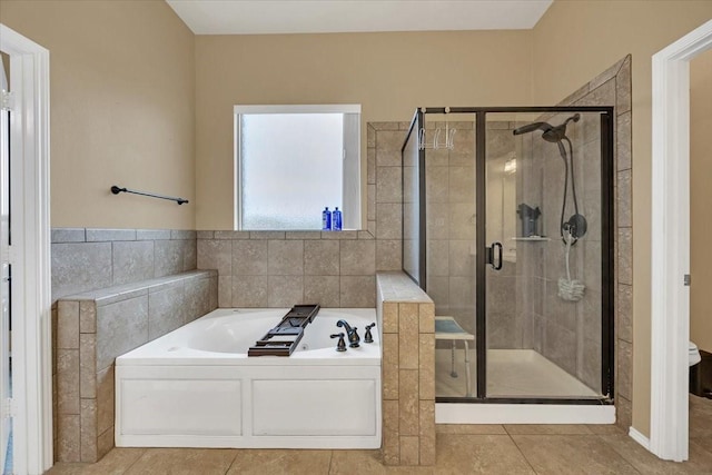 full bathroom with a stall shower, tile patterned flooring, and a bath