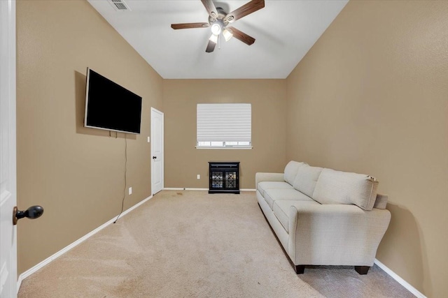 living area featuring carpet floors, a ceiling fan, and baseboards