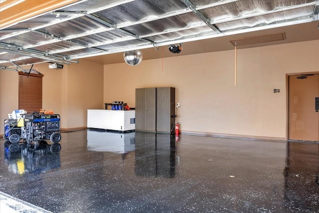 garage with a garage door opener and baseboards