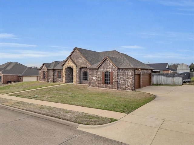 french country style house with brick siding, roof with shingles, a garage, driveway, and a front lawn