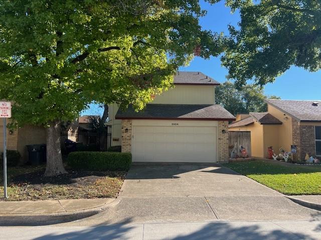 view of front of property with a garage, concrete driveway, and brick siding