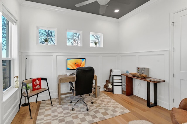 office with ornamental molding, wood finished floors, a wealth of natural light, and a decorative wall