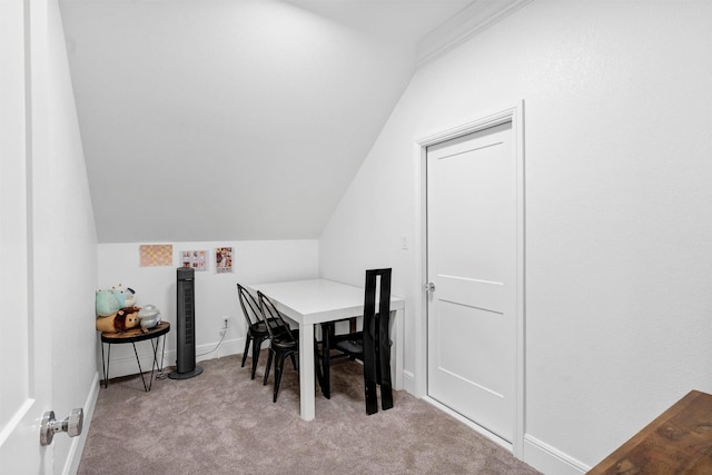 dining area featuring vaulted ceiling, carpet floors, and baseboards