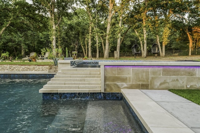 view of dock with an outdoor pool