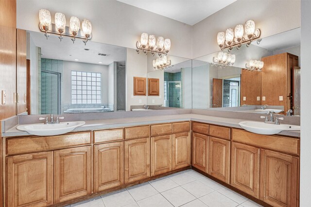 full bath with tile patterned floors, a shower stall, and a sink