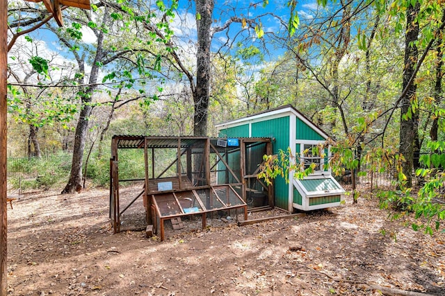 view of poultry coop with a view of trees