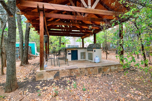 view of patio with grilling area and an outdoor kitchen