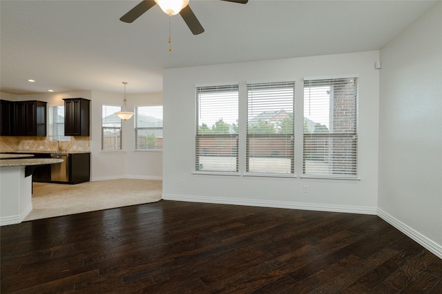 unfurnished living room with a sink, baseboards, light wood-style floors, and recessed lighting