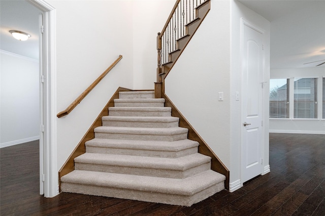 stairway with baseboards and hardwood / wood-style flooring