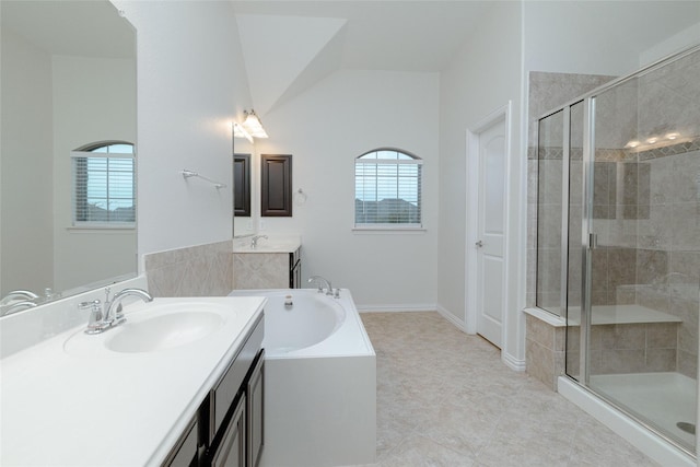 bathroom with two vanities, a shower stall, a garden tub, and a sink