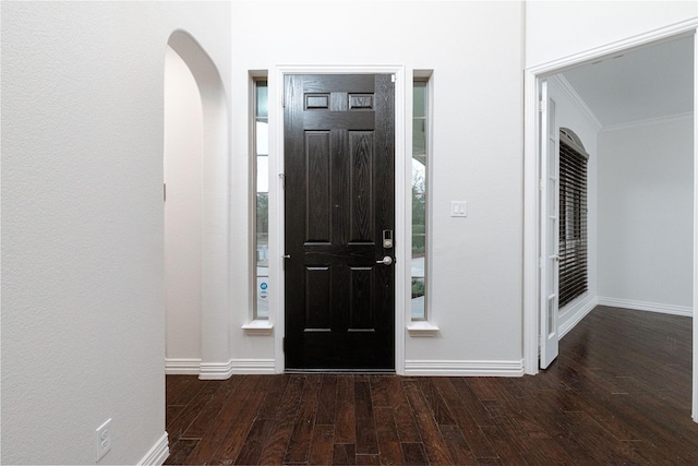 entrance foyer featuring ornamental molding, baseboards, and wood finished floors