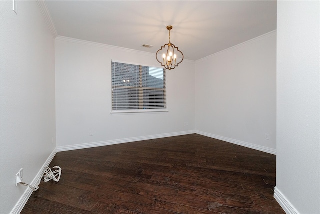 spare room featuring a chandelier, baseboards, wood finished floors, and ornamental molding