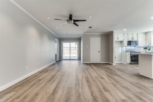 unfurnished living room featuring ceiling fan, light wood-type flooring, baseboards, and ornamental molding