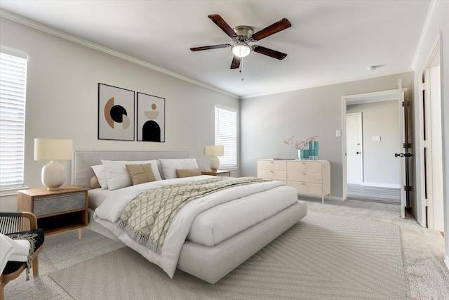 bedroom with ceiling fan, baseboards, light carpet, and ornamental molding