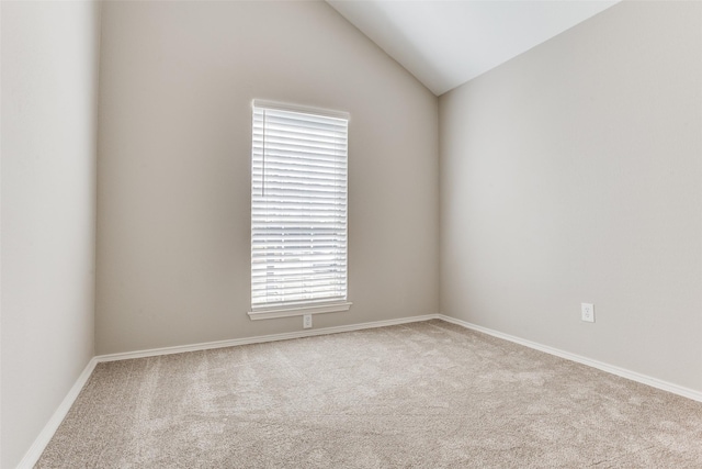 empty room with lofted ceiling and carpet