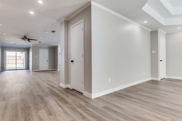 empty room with crown molding, baseboards, light wood-type flooring, recessed lighting, and a ceiling fan